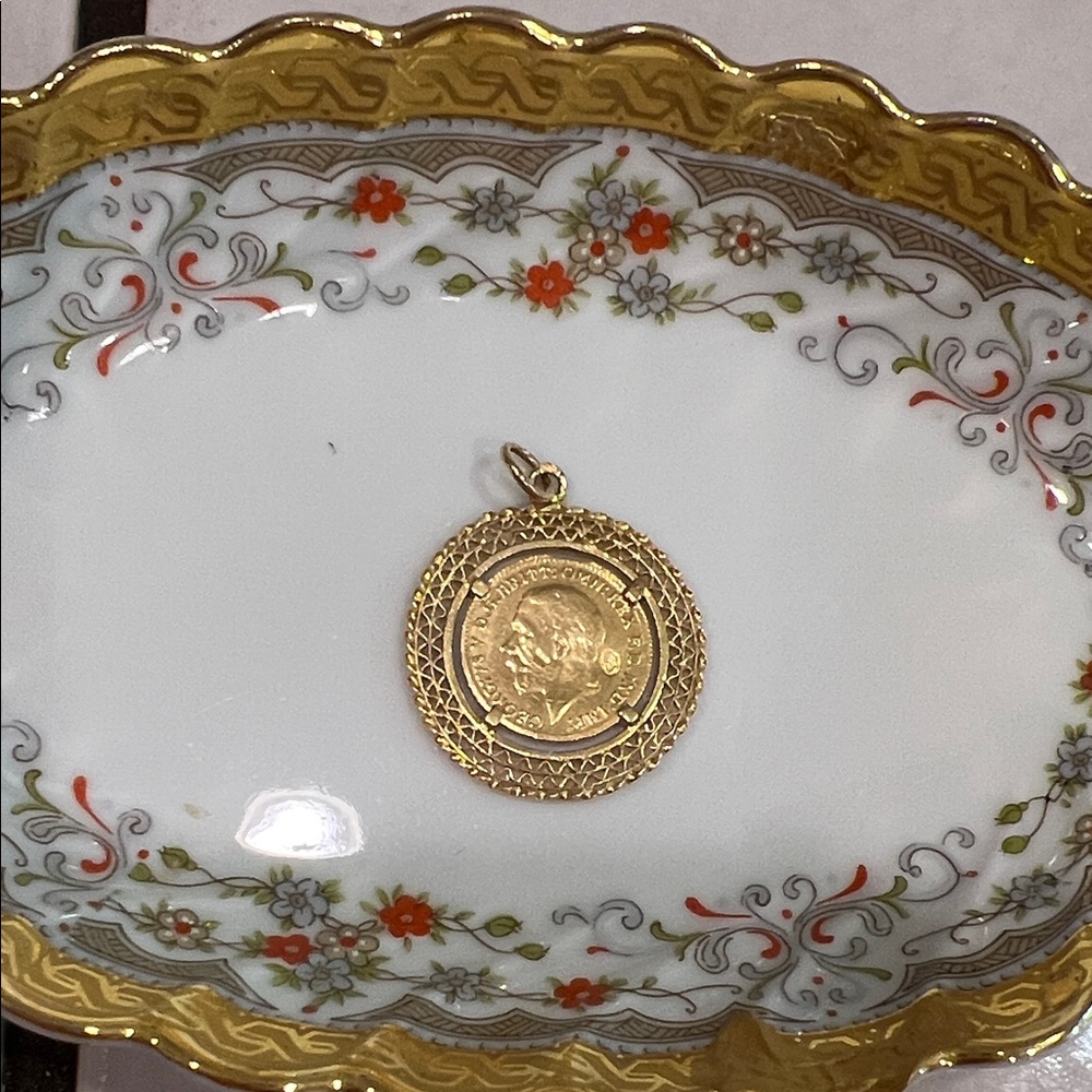 18k dime size coin in an 18k gold frame